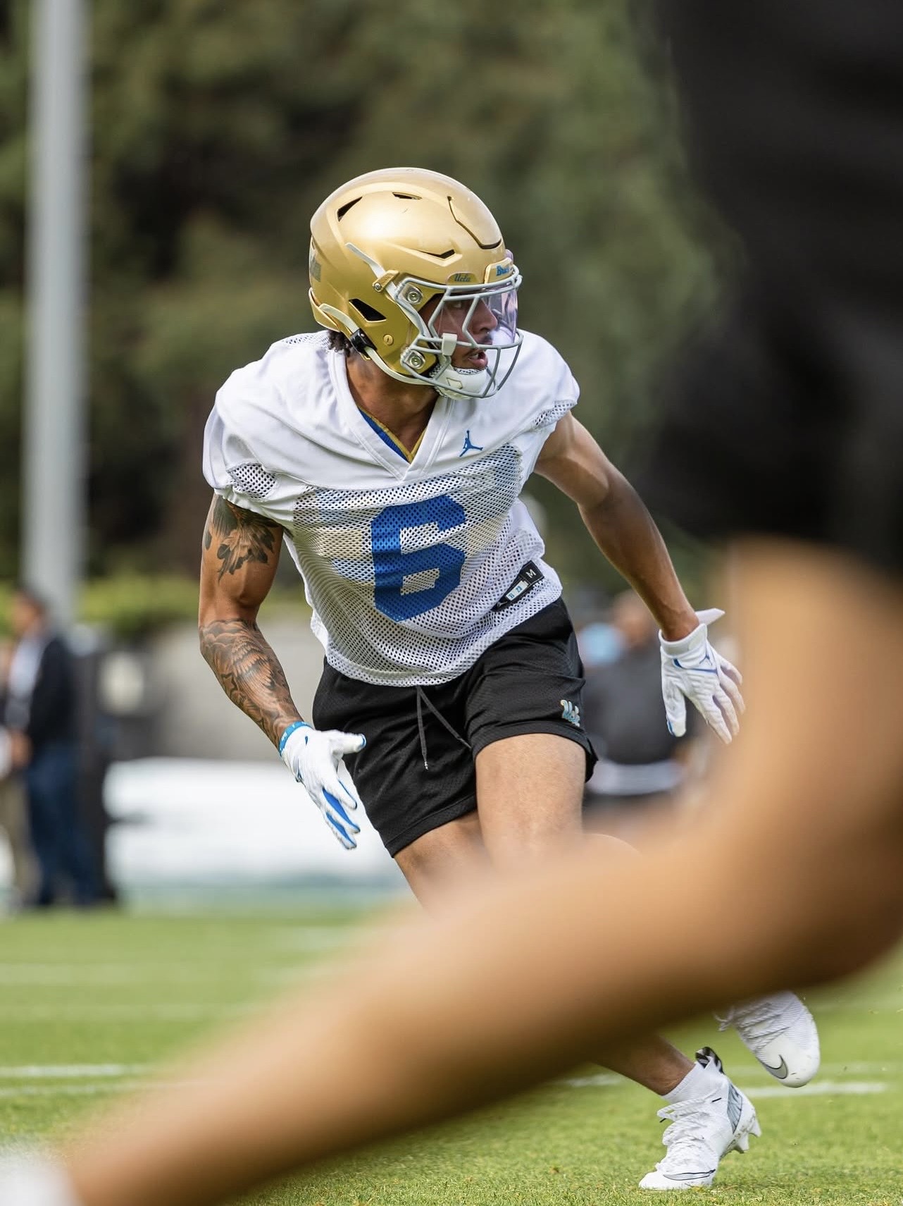 Tao Johnson, UCLA safety, in gold helmet